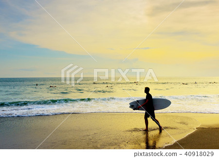 Surfer walking surfboard tropical beach Surfer walking surfboard tropical beach 40918029