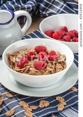 Tasty breakfast with milk and raspberries. Tasty breakfast with milk and raspberries. 40918909