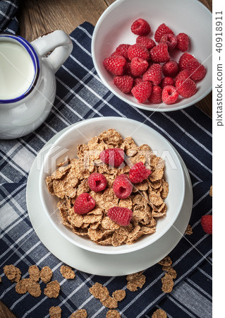 Tasty breakfast with milk and raspberries. Tasty breakfast with milk and raspberries. 40918911