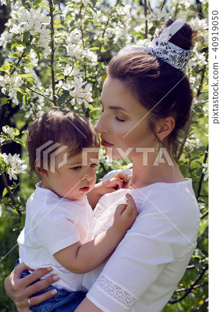 mother and son standing in the trees blooming 40919050