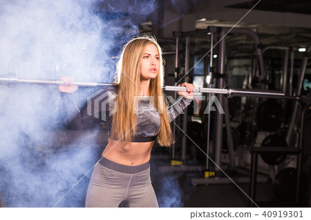 sport, fitness, training and happiness concept - sporty woman with barbell in gym sport, fitness, training and happiness concept - sporty woman with barbell in gym 40919301