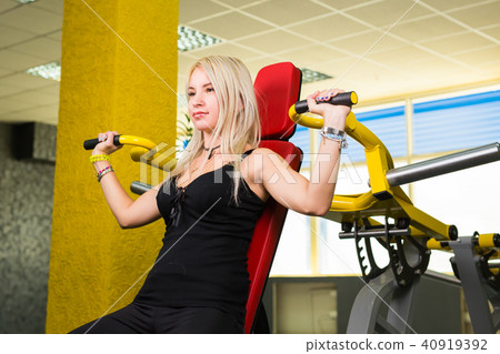 fitness woman execute exercise with exercise machine in gym fitness woman execute exercise with exercise machine in gym 40919392
