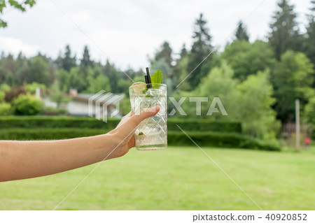glass of mojito in female hand glass of mojito in female hand 40920852