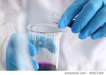 A male chemist holds test tube of glass in A male chemist holds test tube of glass in 40921369