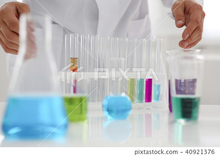 A male chemist holds test tube of glass in 40921376