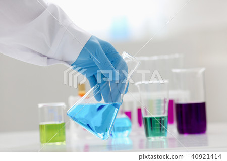 A male chemist holds test tube of glass in A male chemist holds test tube of glass in 40921414