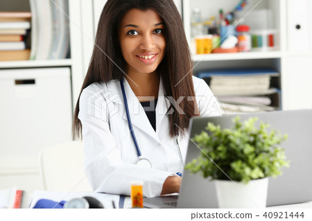 Beautiful smiling female doctor sit at workplace Beautiful smiling female doctor sit at workplace 40921444