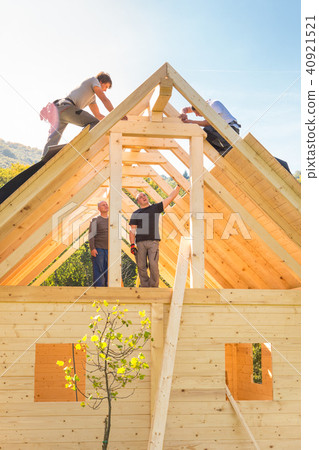 Builders at work with wooden roof construction. Builders at work with wooden roof construction. 40921521