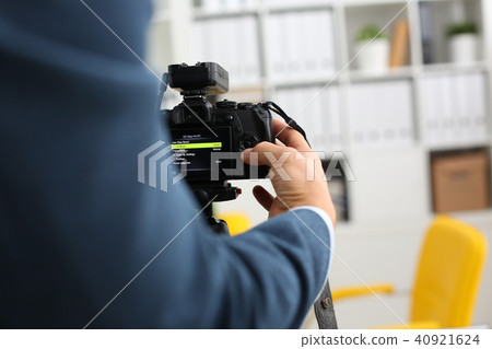 Male arms in suit mount camcorder to tripod Male arms in suit mount camcorder to tripod 40921624