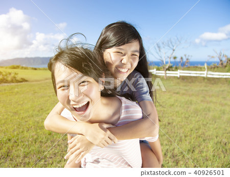 teenager girls playing piggyback and having fun 40926501