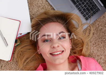 young beautiful woman lie on floor have a lot of work is tired young beautiful woman lie on floor have a lot of work is tired 40927902