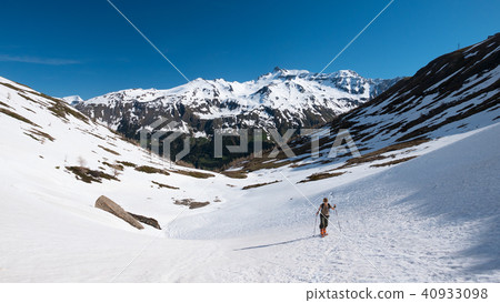 Alpinist hiking ski touring on snowy slope Alpinist hiking ski touring on snowy slope 40933098