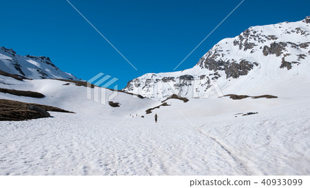 Alpinist hiking ski touring on snowy slope Alpinist hiking ski touring on snowy slope 40933099