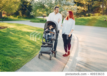cute family in a sunny park cute family in a sunny park 40933633