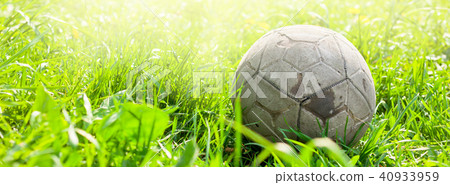 Old soccer ball on the green grass Old soccer ball on the green grass 40933959