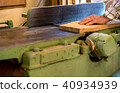 Carpenter tools on wooden table with sawdust. Circular Saw. Cutting a wooden plank 40934939