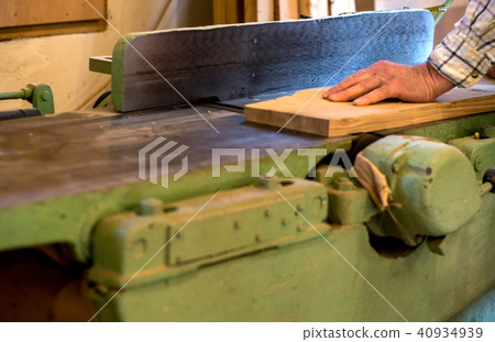 Carpenter tools on wooden table with sawdust. Circular Saw. Cutting a wooden plank 40934939