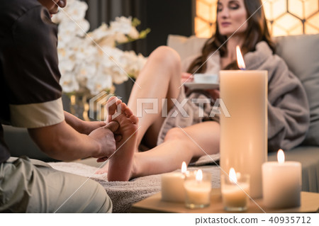 Therapist massaging the foot of a female client in Asian beauty center 40935712
