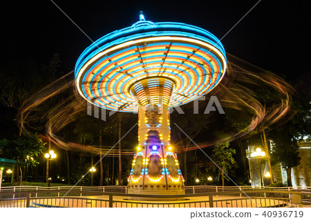 chain carousel ride in amusement park at night 40936719