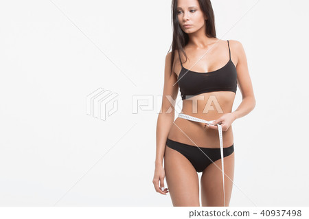 Young beautiful girl measures your body parts of roulette 40937498