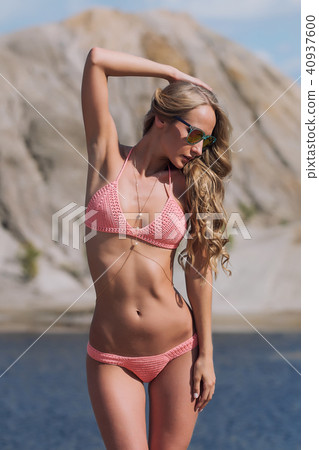 Girl on the sandy beach in a bathing suit Girl on the sandy beach in a bathing suit 40937600