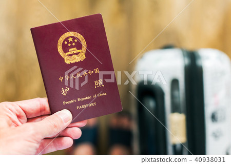 Hand holding a chinese passport Hand holding a chinese passport 40938031