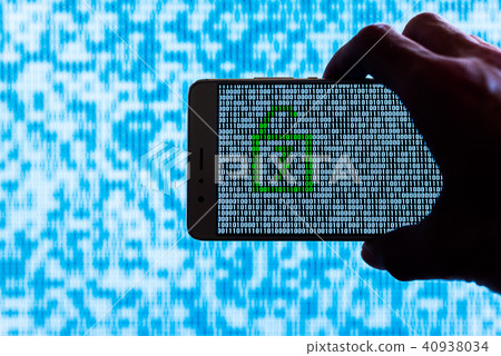 Hand holding a smartphone with a binary locker 40938034