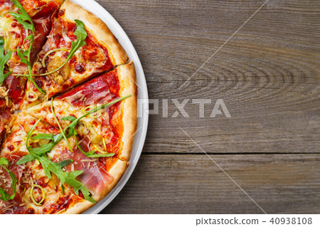 Pizza with prosciutto and arugula, copy space. 40938108