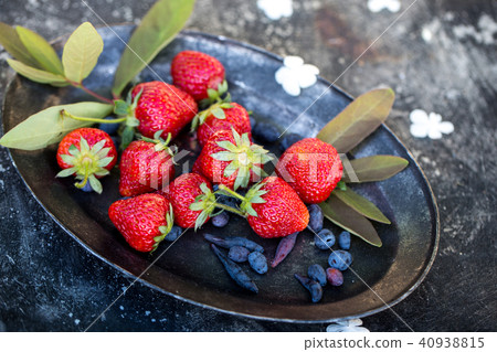 spring strawberry in the garden on a plate spring strawberry in the garden on a plate 40938815