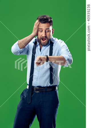 Handsome businessman checking his wrist-watch Isolated on white background 40939236