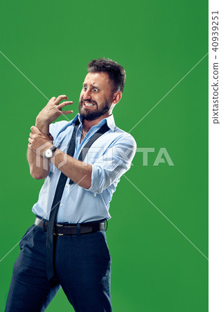 A hand on a green background is squeezed into a fist and wants to commit violence, hit someone A hand on a green background is squeezed into a fist and wants to commit violence, hit someone 40939251