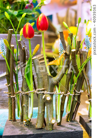 Red tulips and tree branches home flower decoration close-up Red tulips and tree branches home flower decoration close-up 40939363