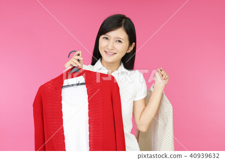 A smiling woman with clothing A smiling woman with clothing 40939632