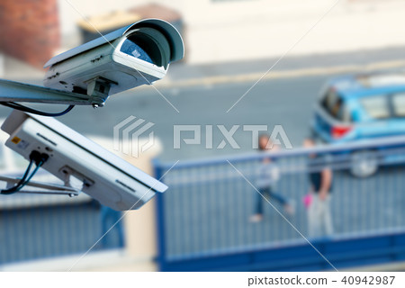 security CCTV camera with street on background 40942987
