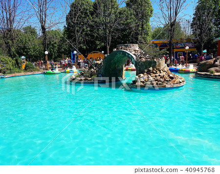 Pool with blue water and water machines as attractions in the city amusement park Pool with blue water and water machines as attractions in the city amusement park 40945768