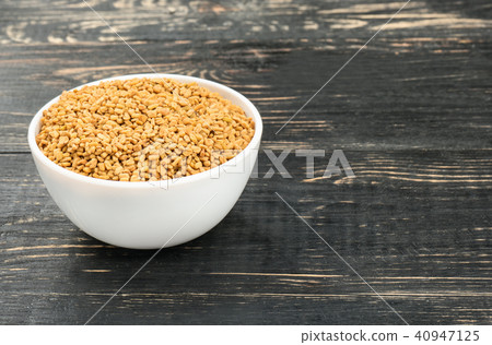 Grains of fenugreek in bowl Grains of fenugreek in bowl 40947125