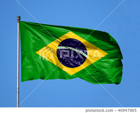 National flag of Brazil on a flagpole in front of blue sky 40947865