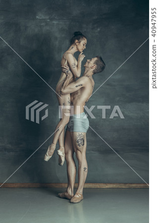 The young modern ballet dancers posing on gray studio background 40947955
