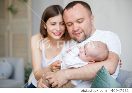 Picture of cuddling parents with newborn son Picture of cuddling parents with newborn son 40947981
