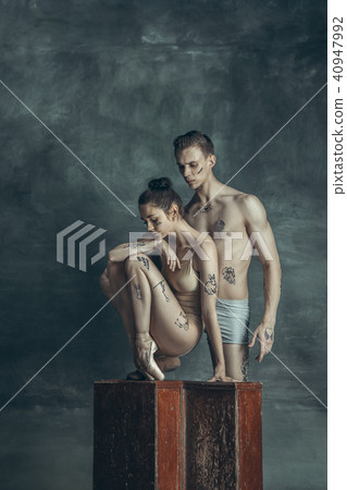 The young modern ballet dancers posing on gray studio background 40947992