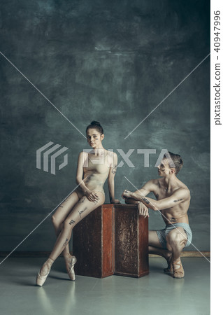 The young modern ballet dancers posing on gray studio background 40947996