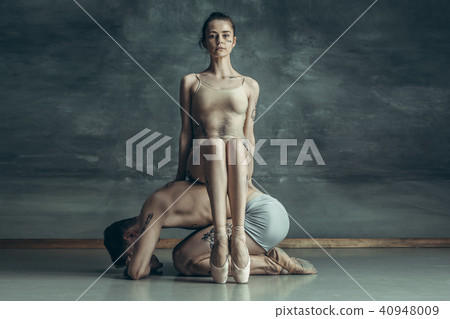 The young modern ballet dancers posing on gray studio background 40948009