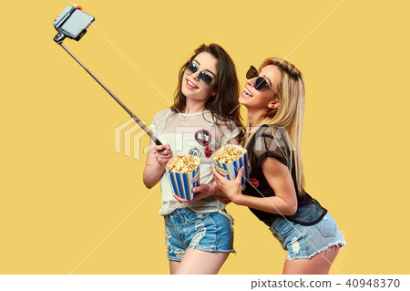 Women taking selfie with popcorn 40948370