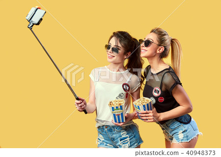 Women taking selfie with popcorn 40948373