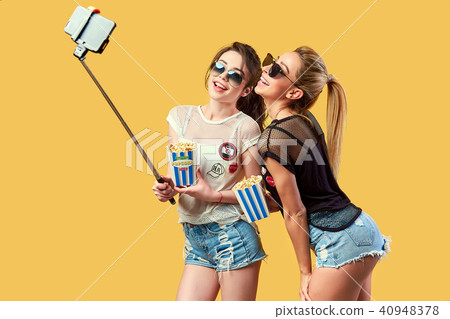 Women taking selfie with popcorn 40948378