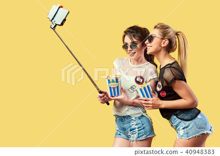 Women taking selfie with popcorn 40948383