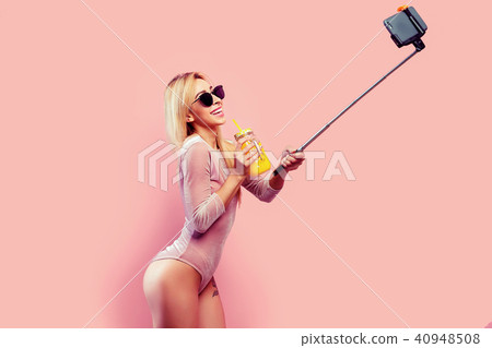 Woman taking selfie with drinking jar 40948508