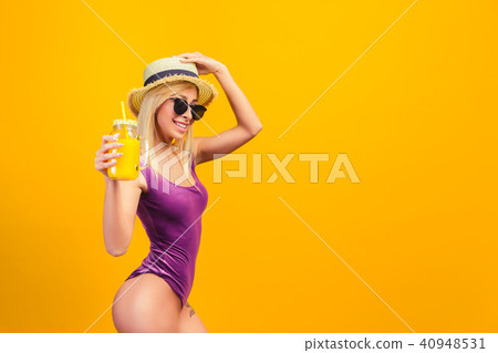 Cheerful woman in hat with drinking jar Cheerful woman in hat with drinking jar 40948531