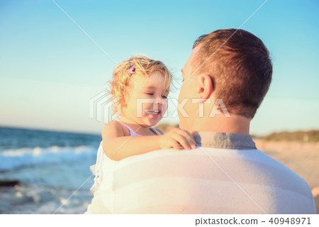 adult father holding his happy blondy child girl adult father holding his happy blondy child girl 40948971
