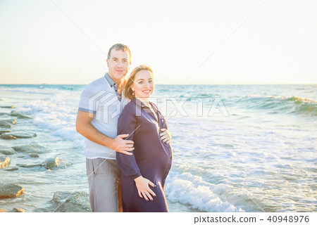 Portrait of happy love pregnant couple embracing Portrait of happy love pregnant couple embracing 40948976